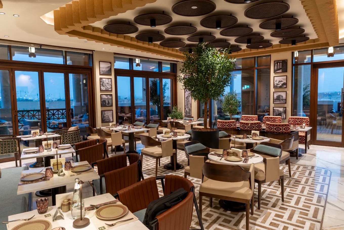 Villa Fayrouz Diriyah — Najdi-inspired dining hall with layered timber ceiling