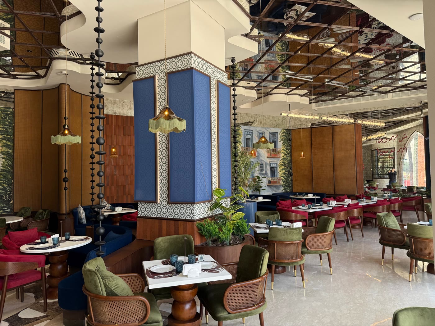 Joori Min Beirut restaurant — mirrored ceiling, Beirut mural and velvet seating
