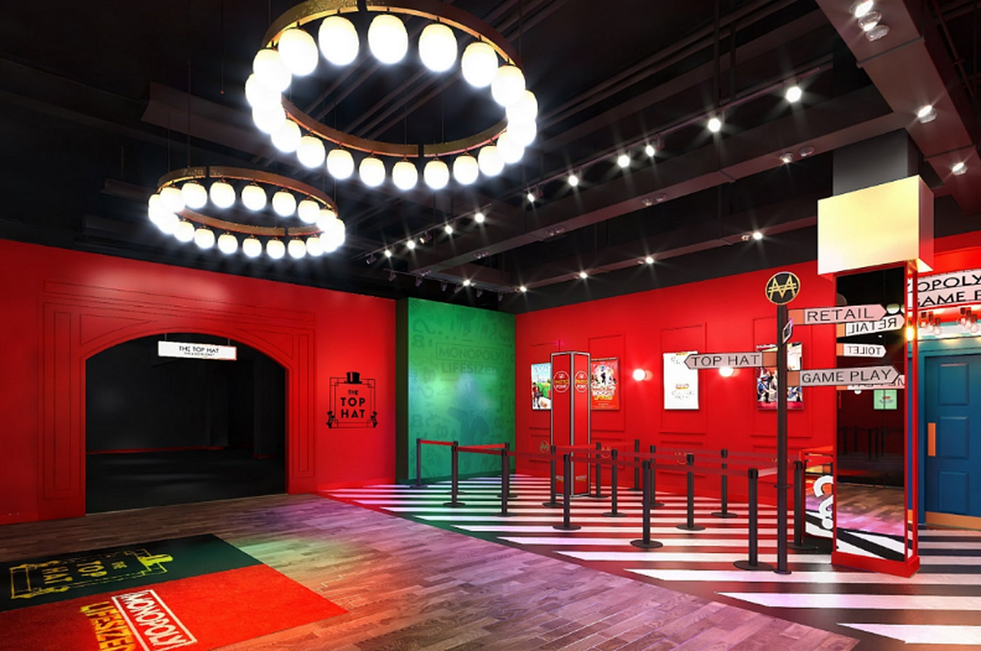 Monopoly Lifesized Riyadh — red entrance hall with ring chandeliers and life-size board